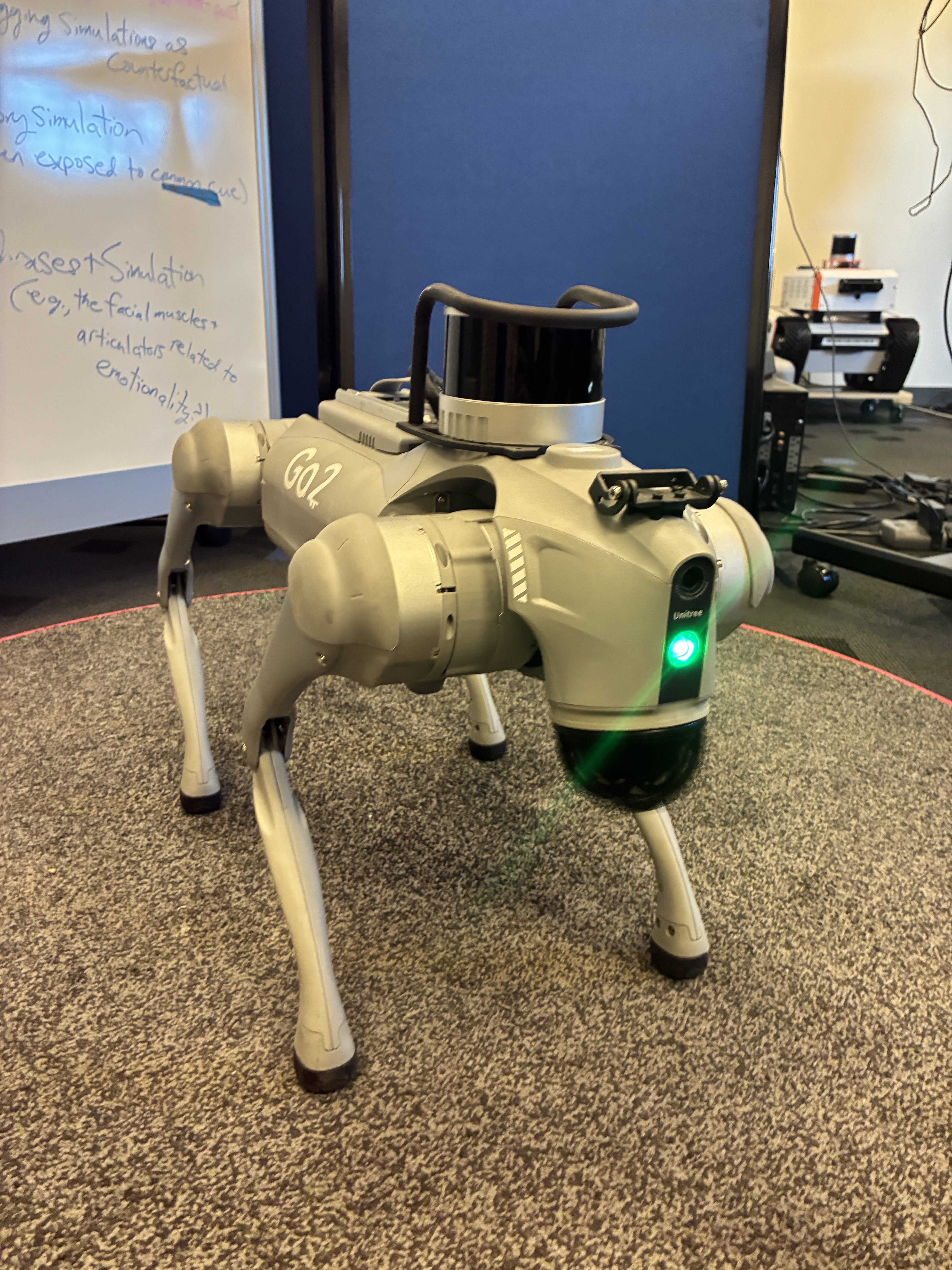 The Unitree Go2 quadruped robot standing in the lab with a LiDAR sensor mounted on its back