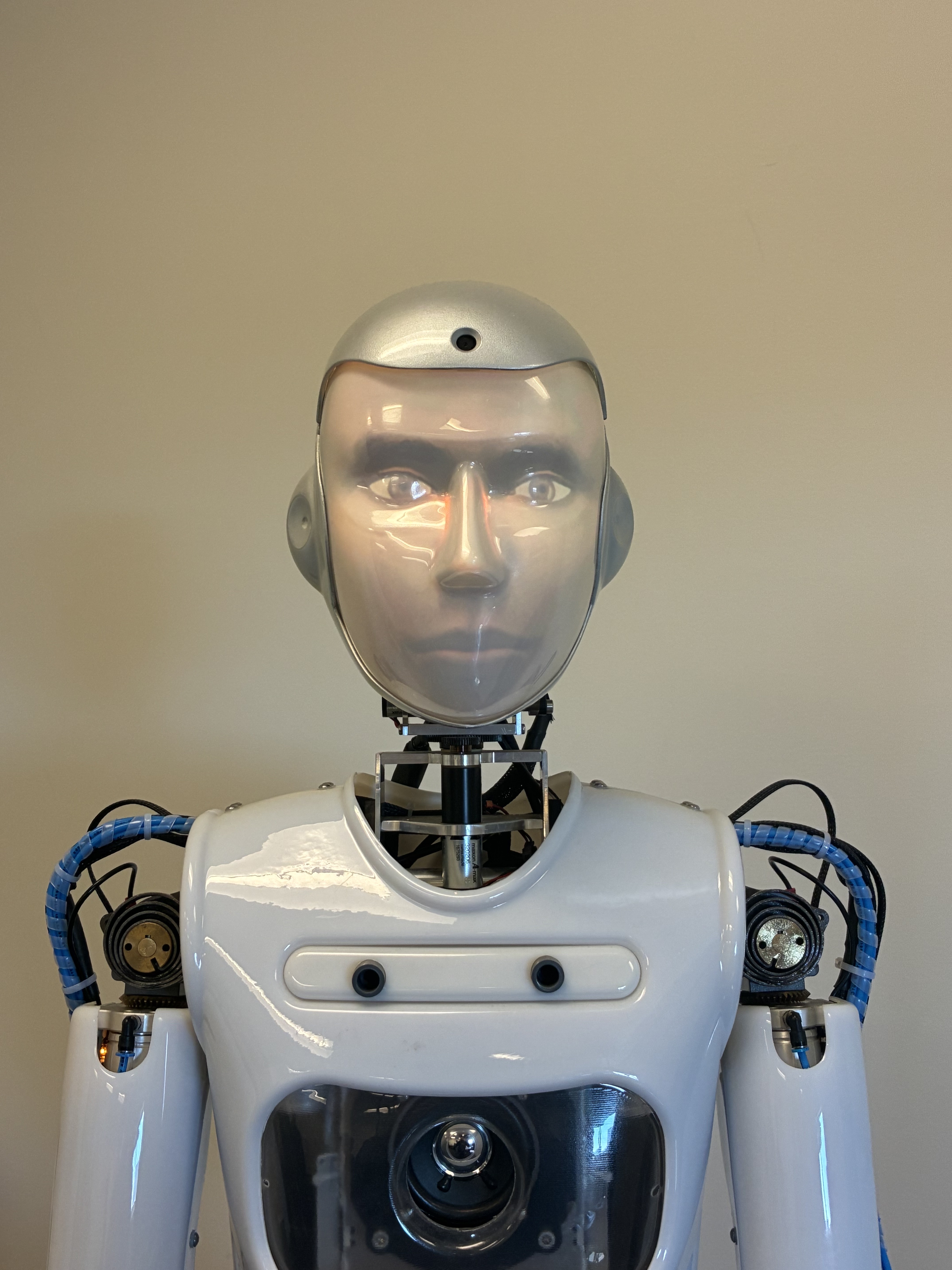 The RoboThespian humanoid robot, a white shell with a metallic face and blue cabling across the shoulders